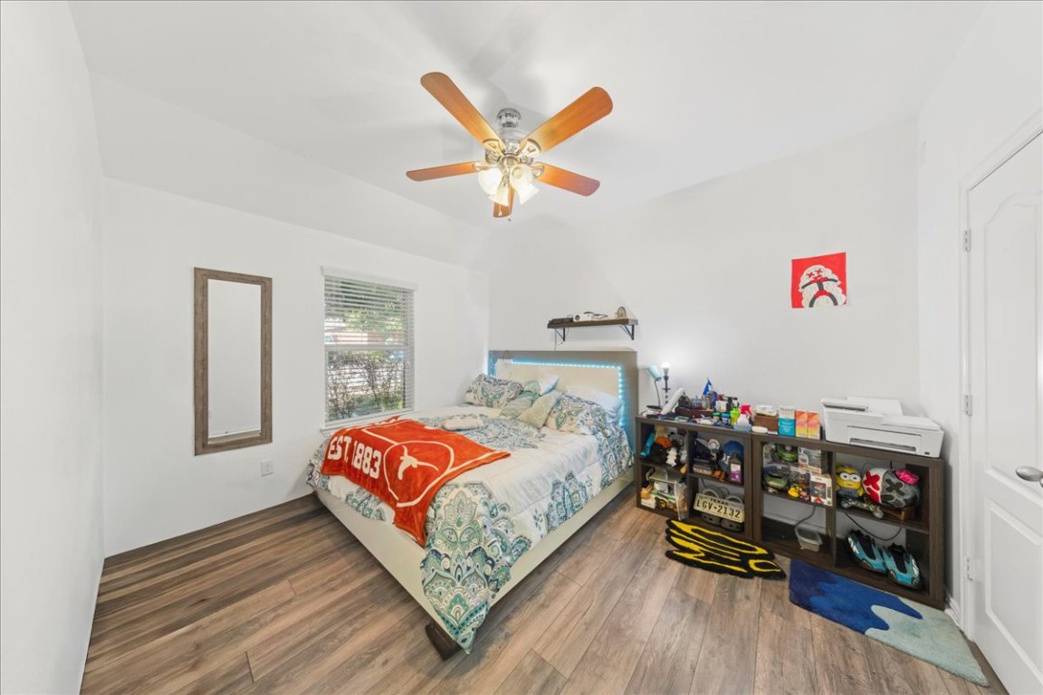 349 Razzmatazz Trail Buda, TX 78610 - Photo 11 of 40 a bedroom with a bed and a chandelier