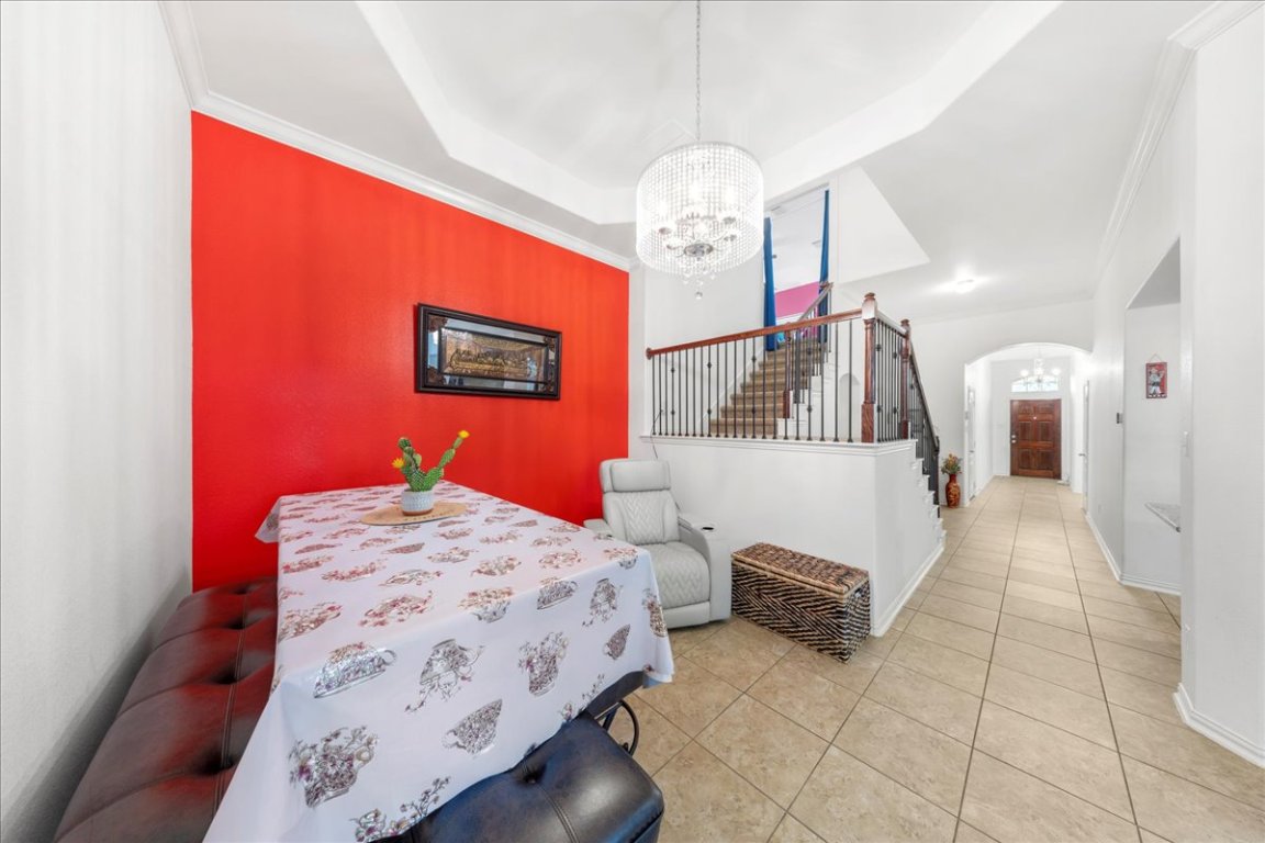 349 Razzmatazz Trail Buda, TX 78610 - Photo 20 of 40 a bedroom with a bed and a chandelier