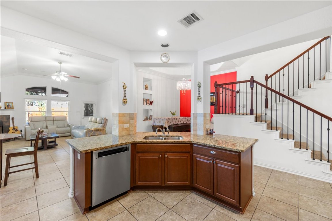 349 Razzmatazz Trail Buda, TX 78610 - Photo 38 of 40 a kitchen with granite countertop a sink and cabinets