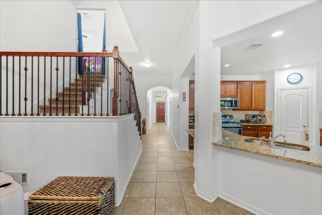 a view of a hallway with a couch and chandelier