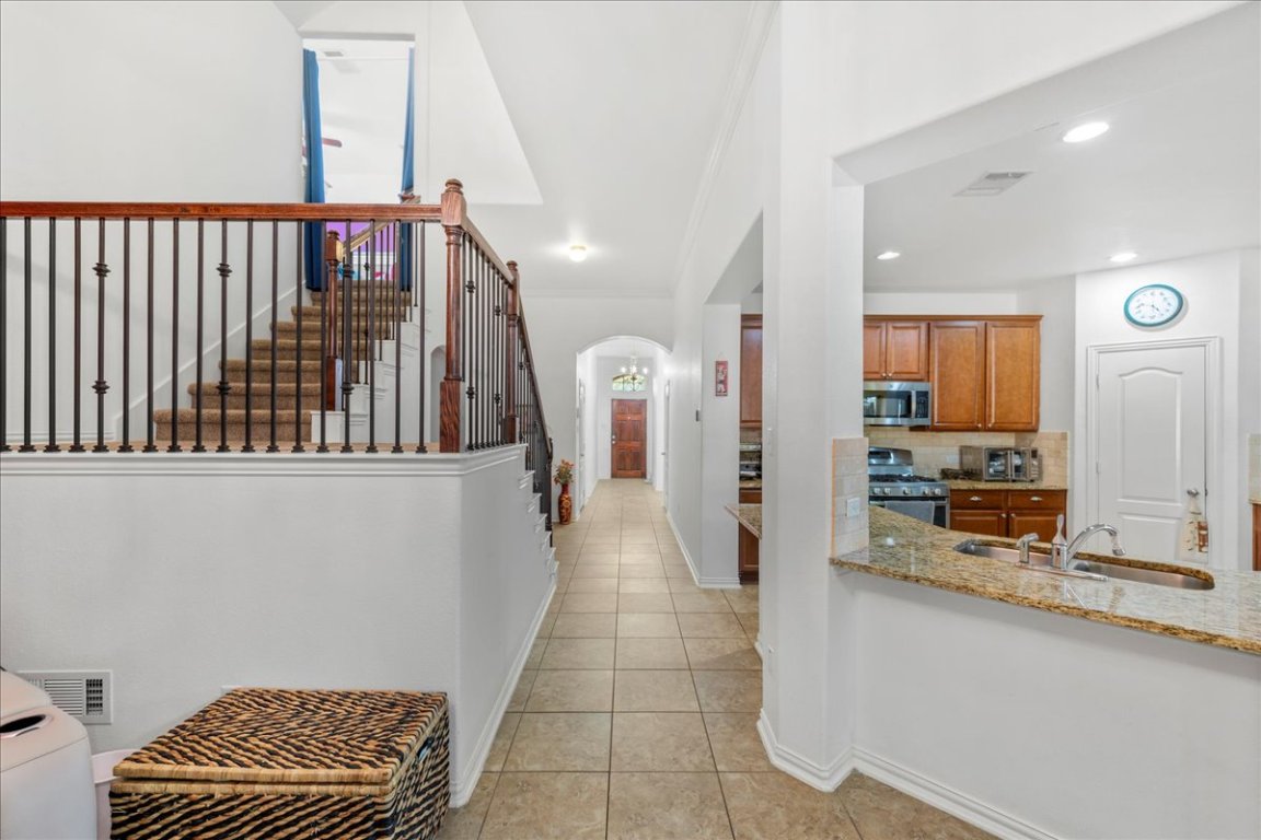 349 Razzmatazz Trail Buda, TX 78610 - Photo 29 of 40 a view of a hallway with a couch and chandelier