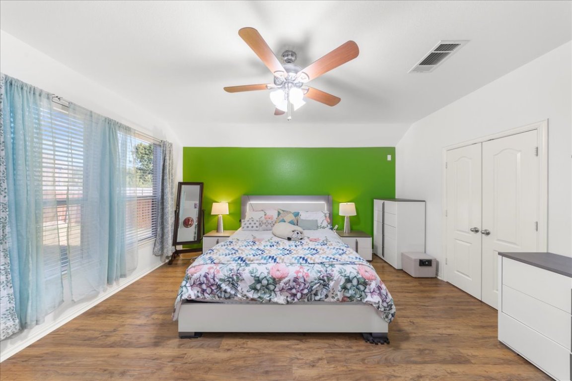 349 Razzmatazz Trail Buda, TX 78610 - Photo 32 of 40 a living room with a bed chandelier and a large window