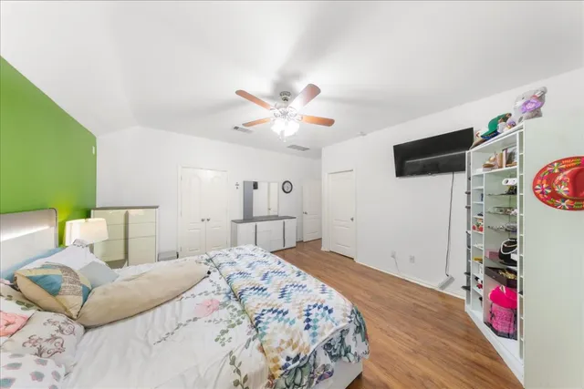 a bed room with a bed and a flat screen tv