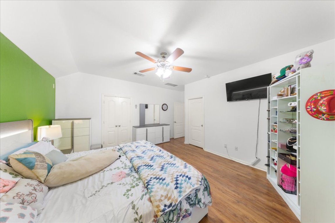 349 Razzmatazz Trail Buda, TX 78610 - Photo 33 of 40 a bed room with a bed and a flat screen tv