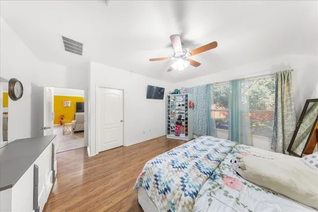 a bedroom with a bed and a large window