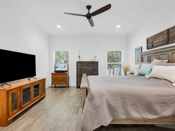 a bedroom with furniture and a flat screen tv