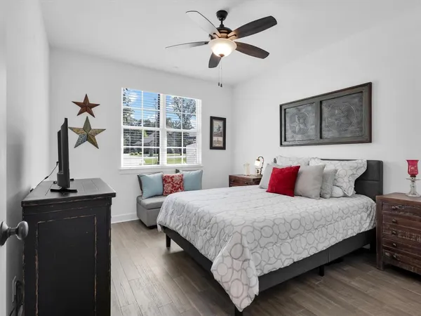 a bedroom with a bed and wooden floor
