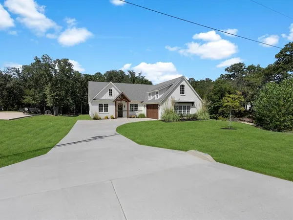 a view of house with yard and green space