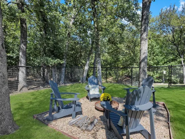 a backyard of a house with yard table and chairs