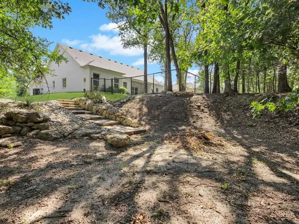 a view of house with yard and green space