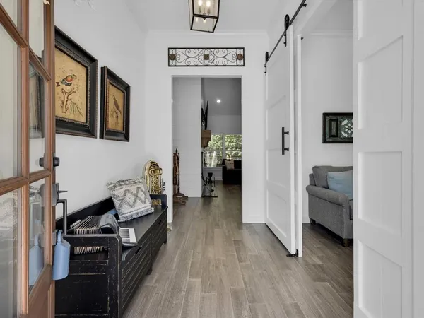 a living room with furniture and a wooden floor