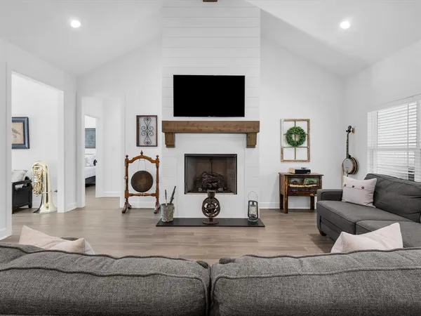 a living room with furniture a fireplace and a flat screen tv
