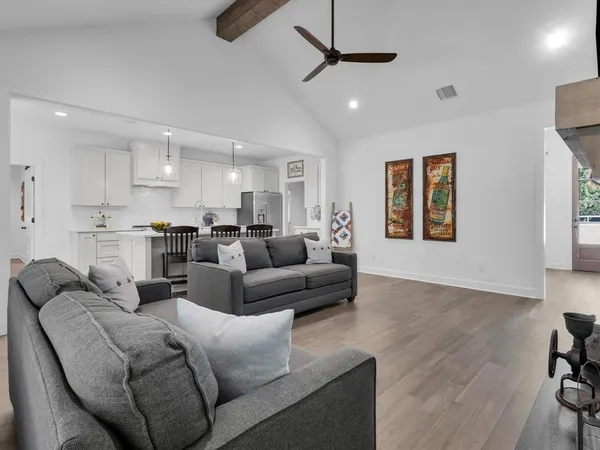 a living room with furniture kitchen and a window