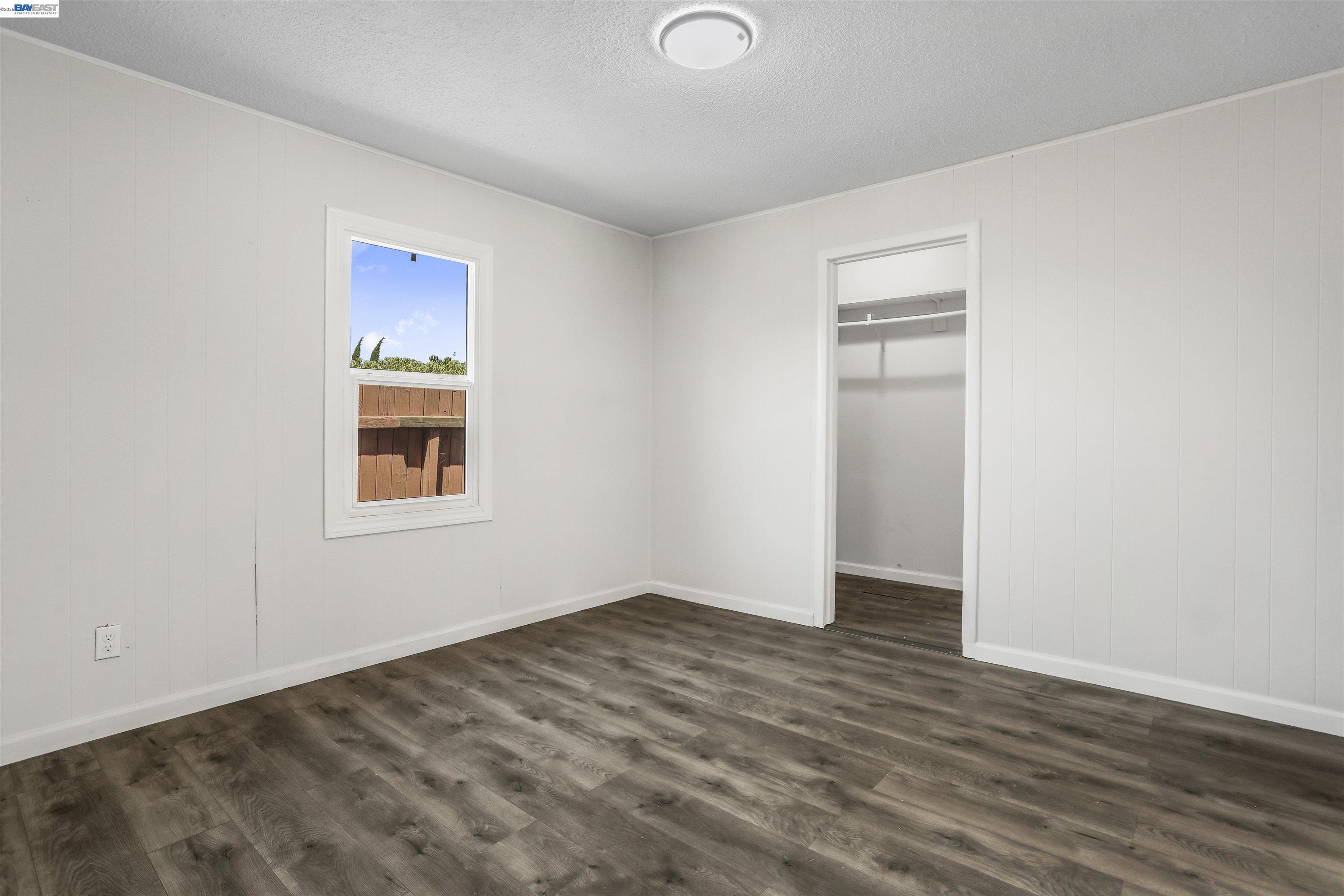1925 Alpha Way Antioch, CA 94509 - Photo 12 of 26 a view of an empty room with wooden floor and a window