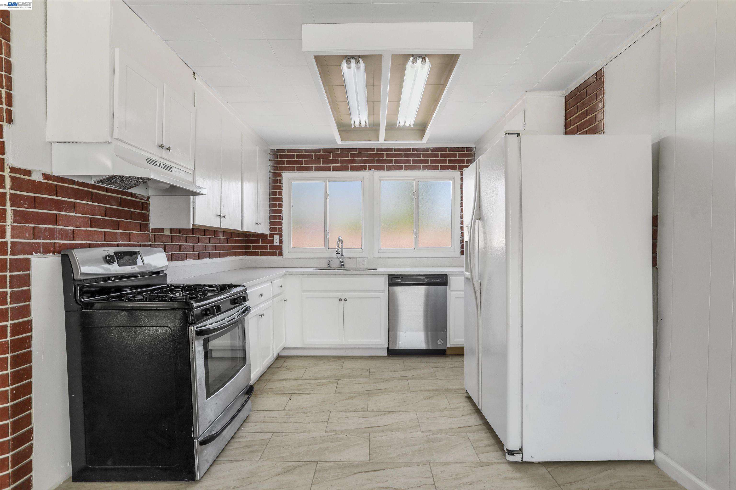 1925 Alpha Way Antioch, CA 94509 - Photo 13 of 26 a kitchen with a stove a sink and a refrigerator