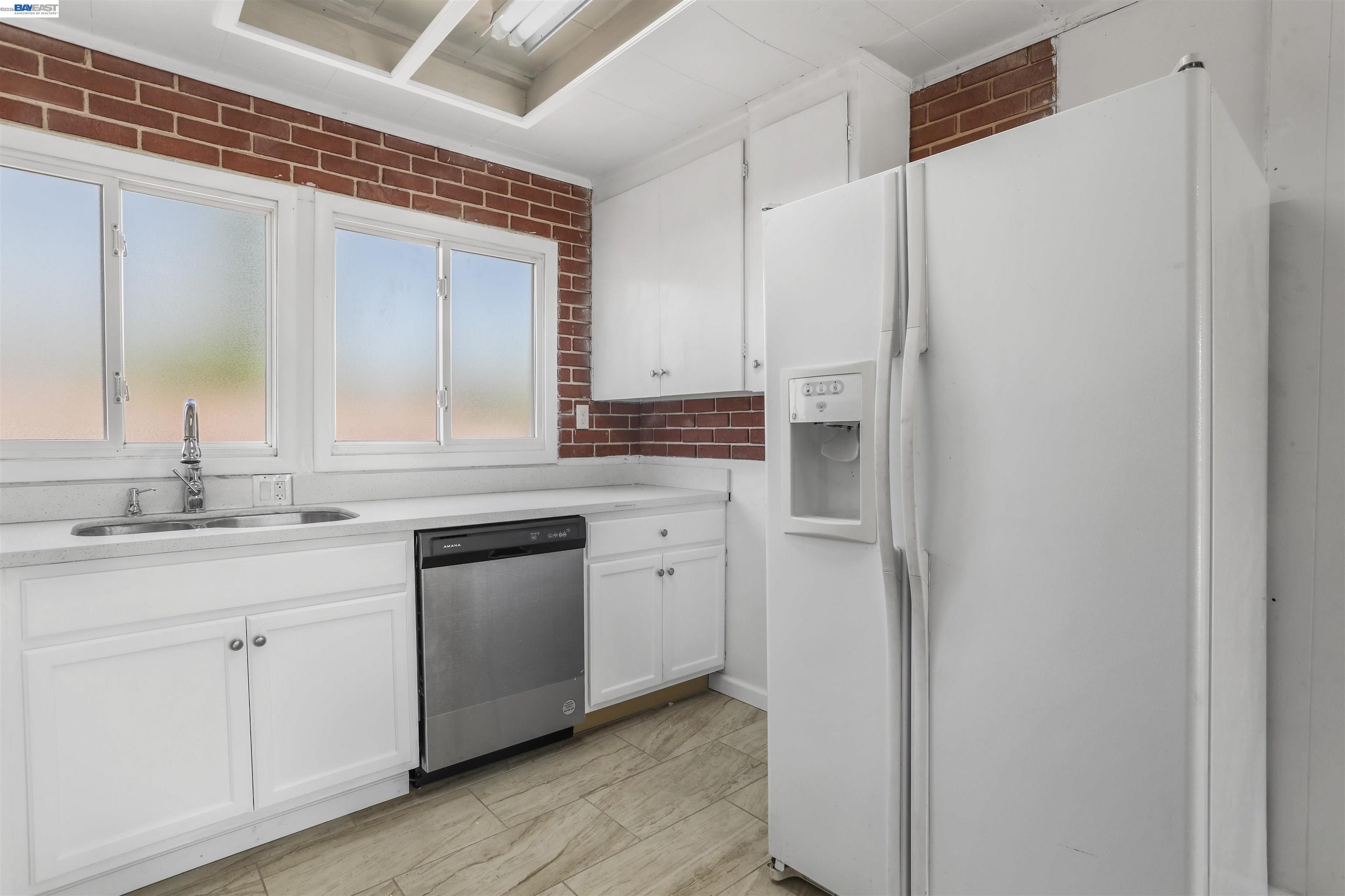 1925 Alpha Way Antioch, CA 94509 - Photo 15 of 26 a kitchen with a refrigerator sink and cabinets