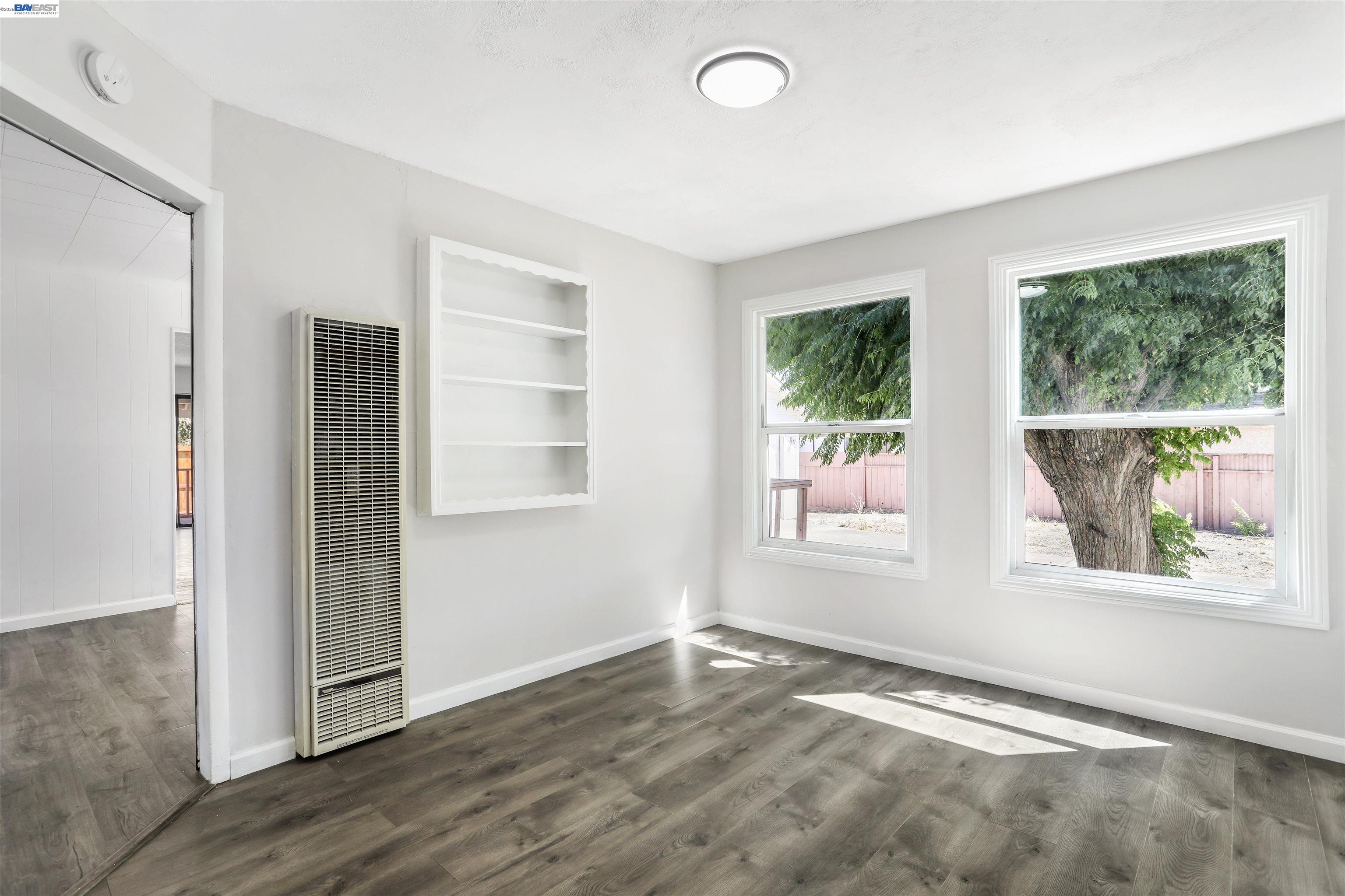 1925 Alpha Way Antioch, CA 94509 - Photo 8 of 26 an empty room with wooden floor and windows