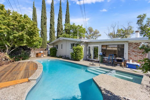a view of a house with swimming pool and sitting area