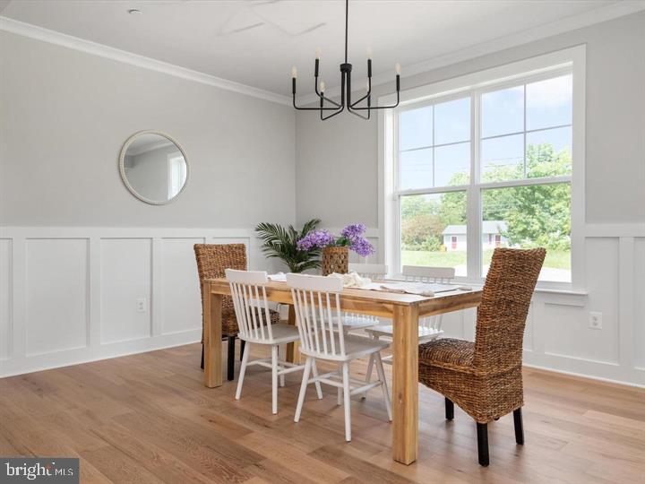 890 Alameda Drive Huntingtown, MD 20639 - Photo 12 of 51 a dining room with furniture a window and wooden floor