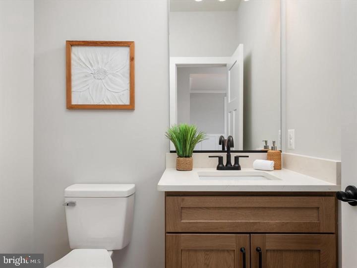 890 Alameda Drive Huntingtown, MD 20639 - Photo 25 of 51 a bathroom with a toilet sink and mirror