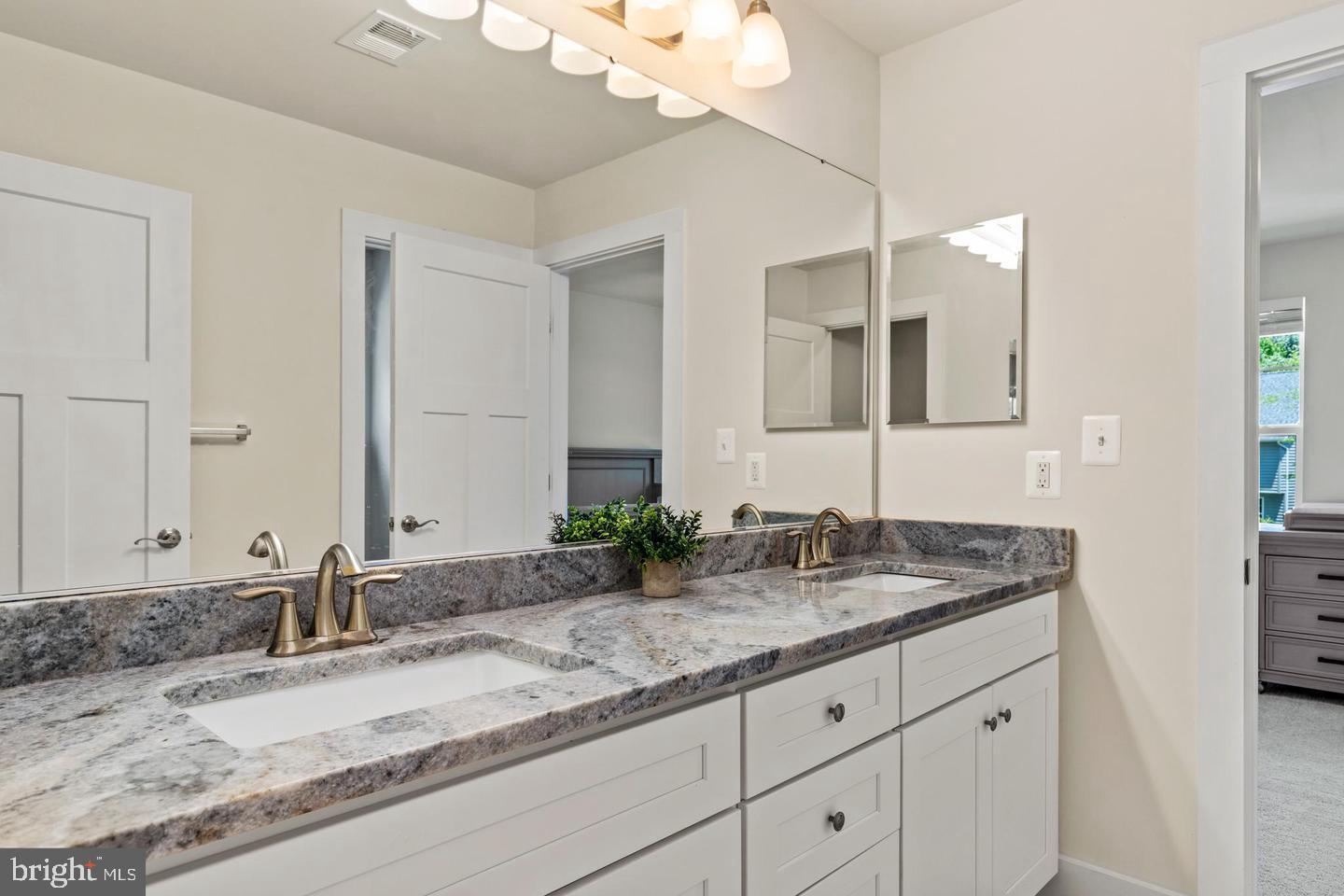 890 Alameda Drive Huntingtown, MD 20639 - Photo 37 of 51 a bathroom with a granite countertop sink and a mirror