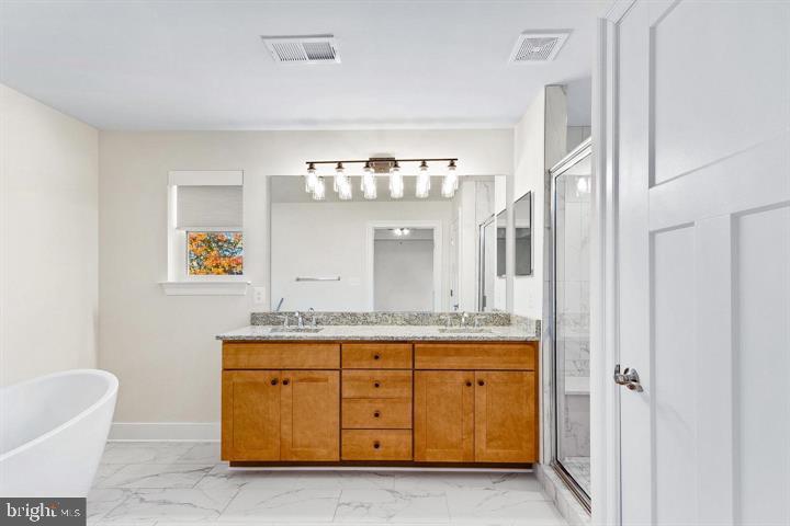 890 Alameda Drive Huntingtown, MD 20639 - Photo 43 of 51 a spacious bathroom with a granite countertop double vanity sink a mirror and a bathtub