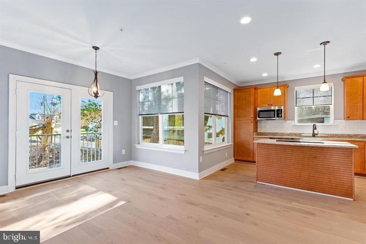 890 Alameda Drive Huntingtown, MD 20639 - Photo 10 of 51 a large kitchen with kitchen island a chandelier stainless steel appliances and a large window