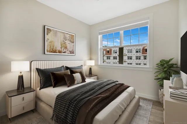 a bedroom with bed and a potted plant
