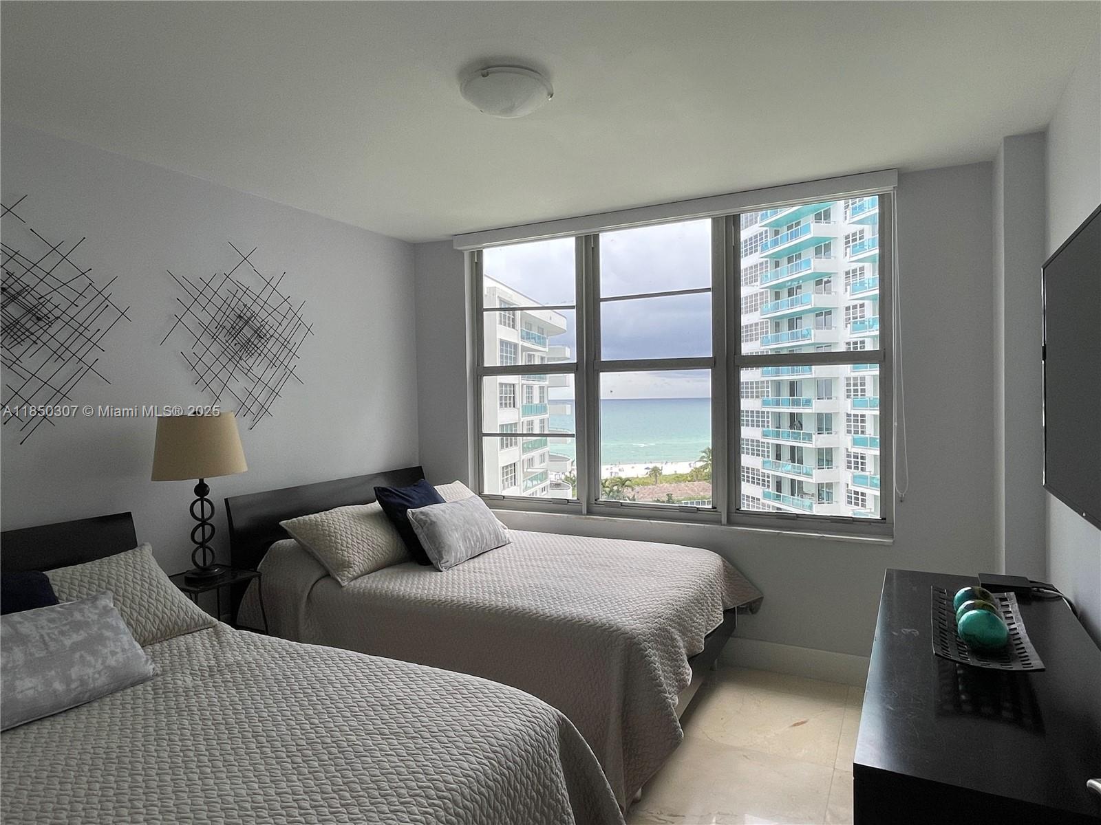 5151 Collins Avenue, Unit 825 Miami Beach, FL 33140 - Photo 15 of 28 a bedroom with a bed and a window