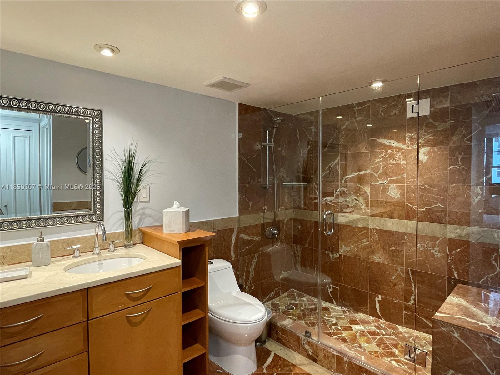 5151 Collins Avenue, Unit 825 Miami Beach, FL 33140 - Photo 21 of 28 a bathroom with a sink toilet and shower