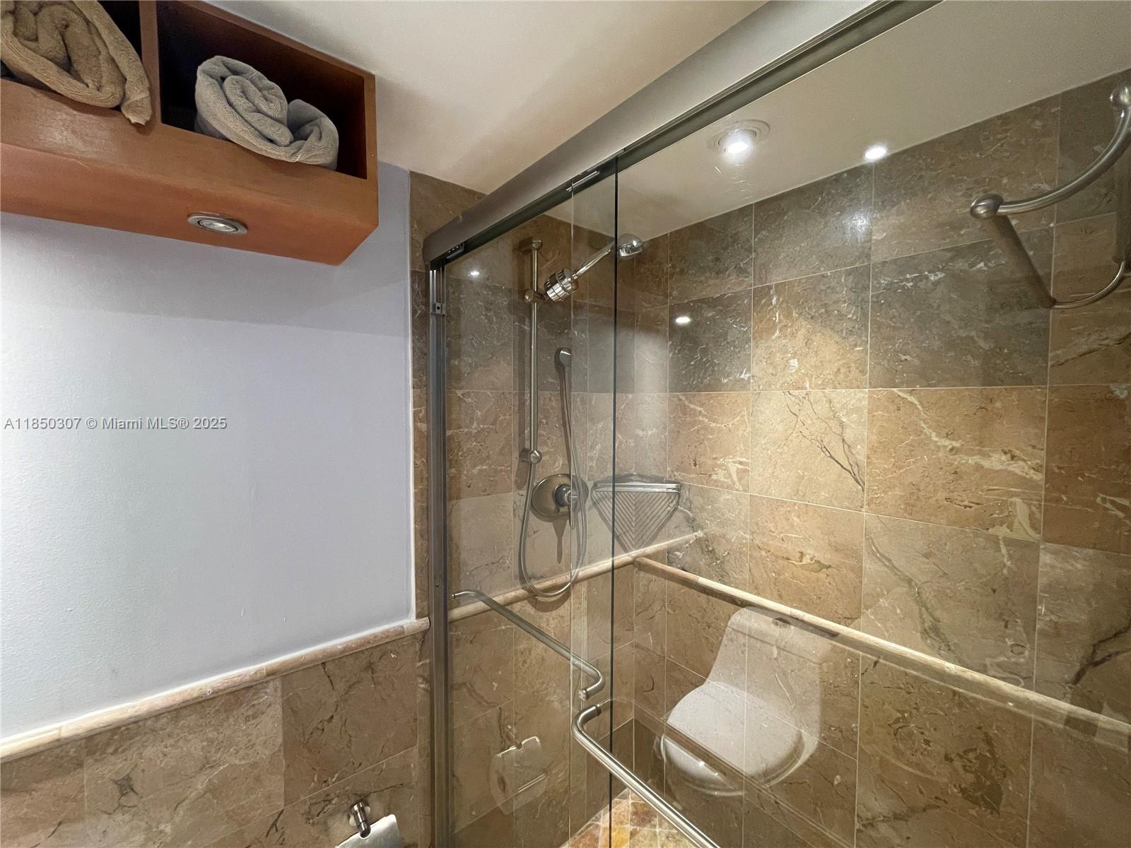 5151 Collins Avenue, Unit 825 Miami Beach, FL 33140 - Photo 24 of 28 a bathroom with a shower