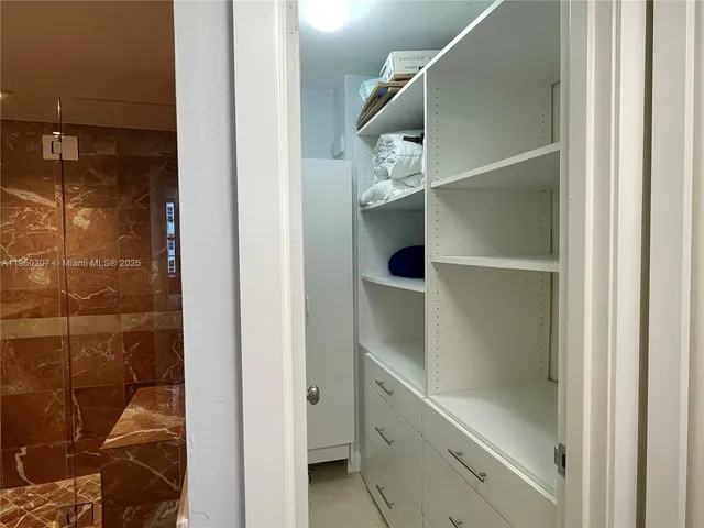 a bathroom with a glass shower door