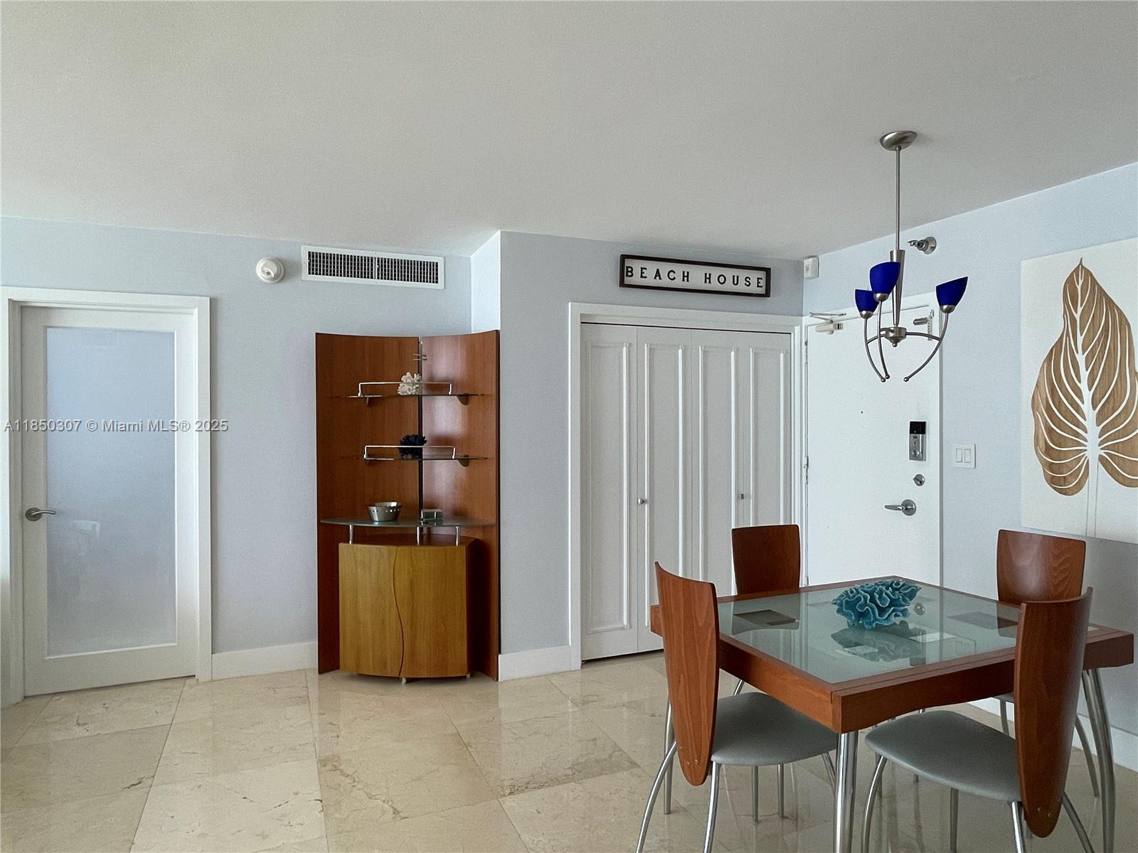 5151 Collins Avenue, Unit 825 Miami Beach, FL 33140 - Photo 6 of 28 a view of a dining room with furniture