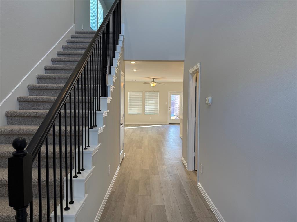 1736 Arches Road Anna, TX 75409 - Photo 10 of 18 Stairs with a high ceiling and wood finished floors
