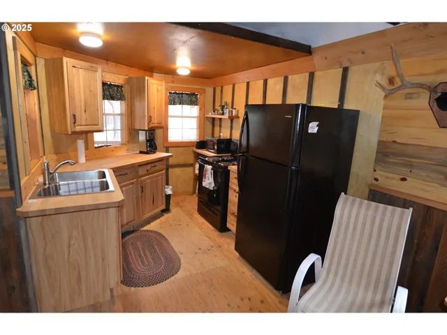a kitchen with stainless steel appliances granite countertop a refrigerator and a stove