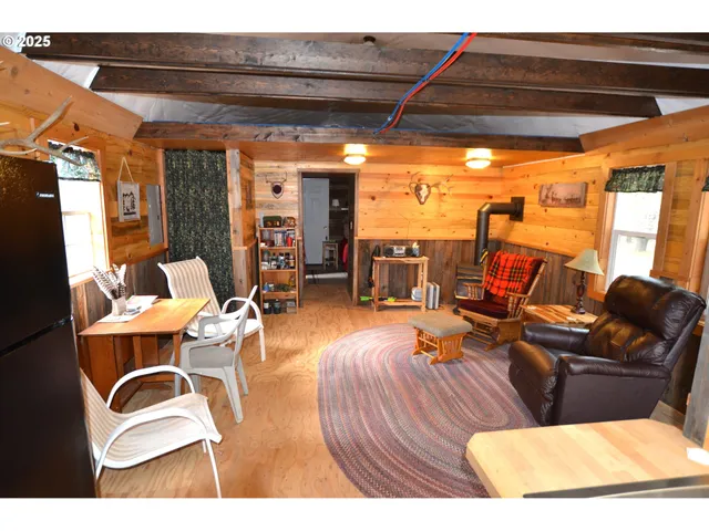 a living room with furniture a rug floor and a large window