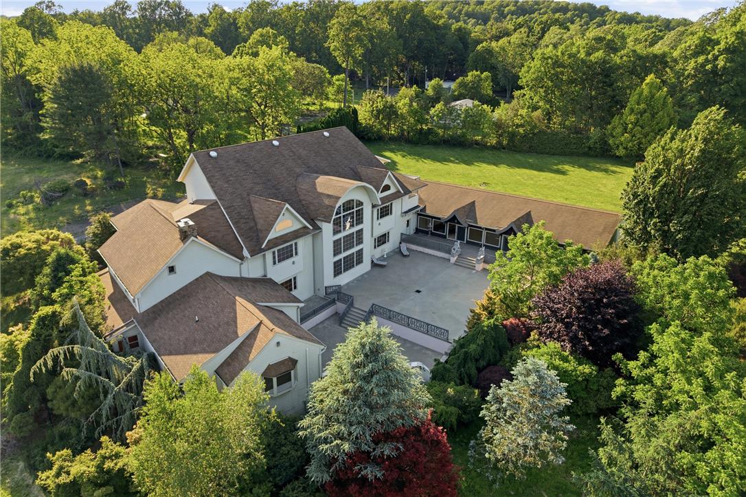 6271 Batman Road Zionsville, PA 18092 - Photo 87 of 100 An aerial perspective reveals a grand residence surrounded by vibrant, mature trees and ample green space.
