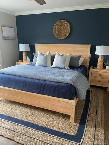 a bed sitting in a bedroom next to a lamp