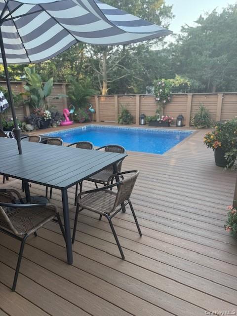 224 Wilmot Road Ocean Beach, NY 11770 - Photo 17 of 17 a view of a patio with table and chairs under an umbrella