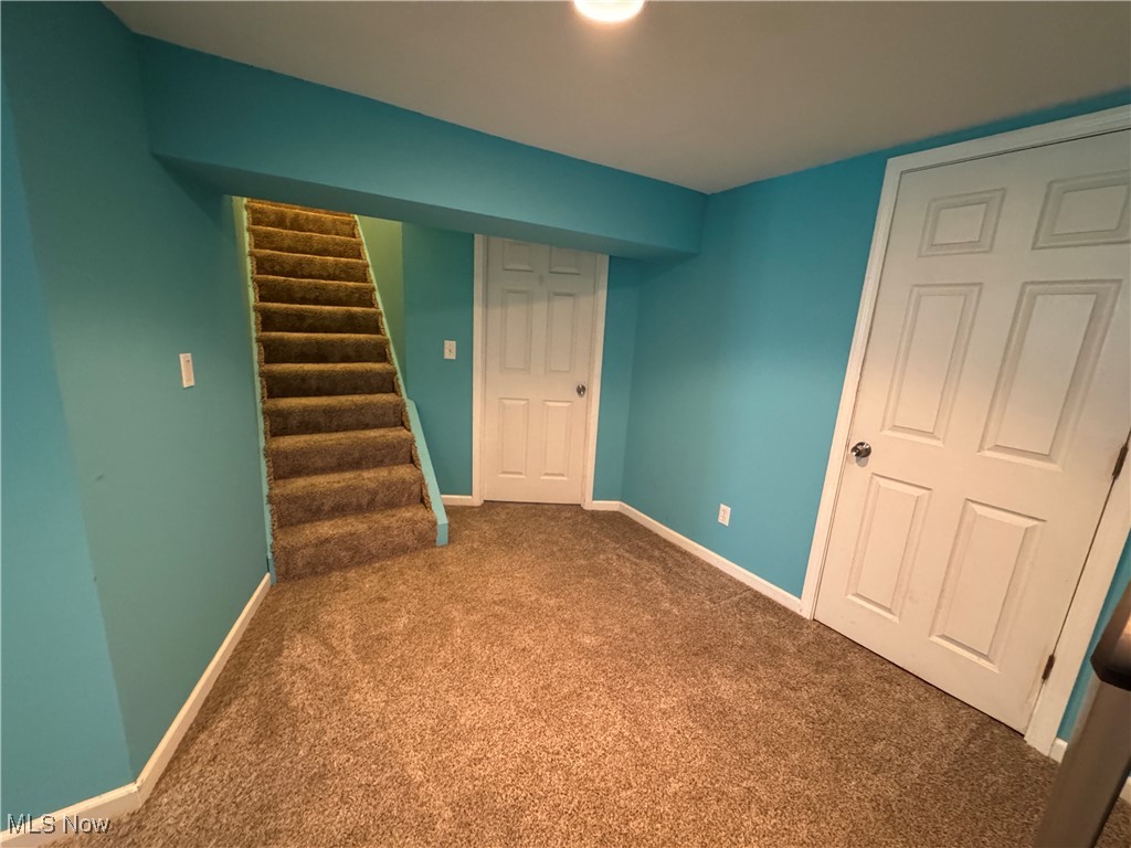 941 Middlebury Road Kent, OH 44240 - Photo 16 of 23 Finished below grade area with carpet floors, baseboards, and stairs
