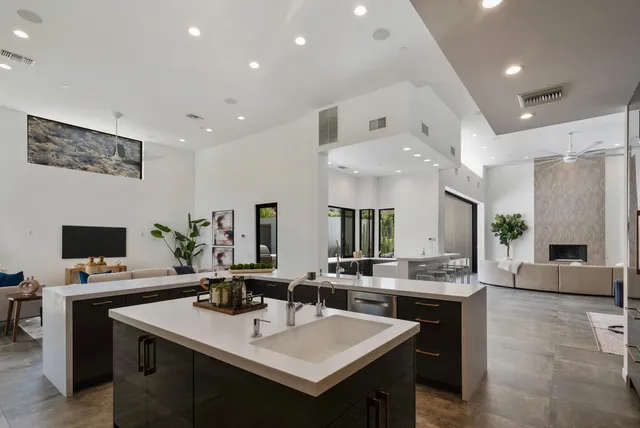 a kitchen with stainless steel appliances a sink stove and cabinets