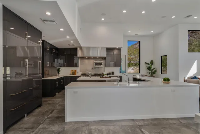 a stove sitting inside of a kitchen with white cabinets