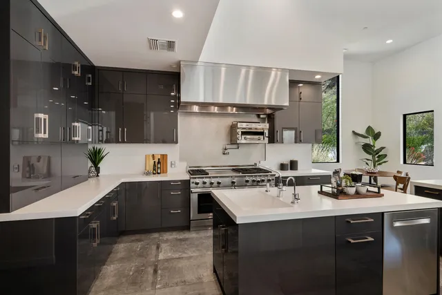 a kitchen with stainless steel appliances granite countertop a sink stove and cabinets