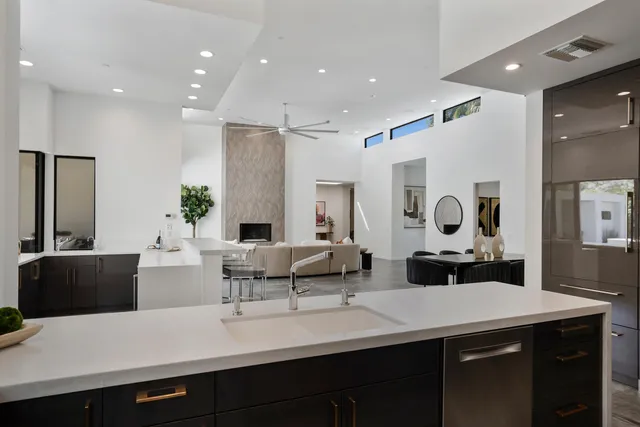 a living room with large window and furniture