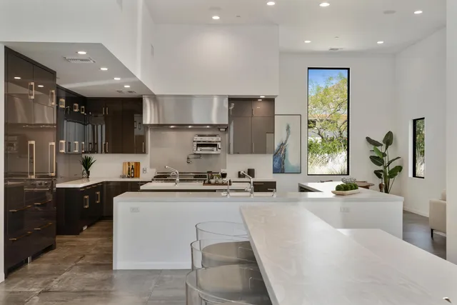 a living room with furniture a potted plant and a lamp