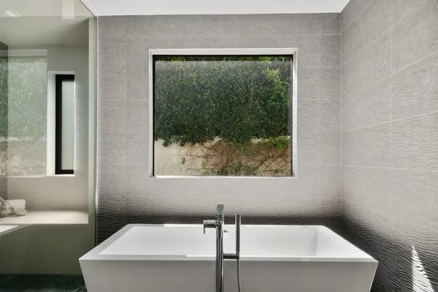 a living room with furniture wooden floor and a large window