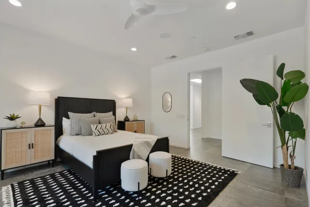 a view of a house with swimming pool lawn chairs and couches