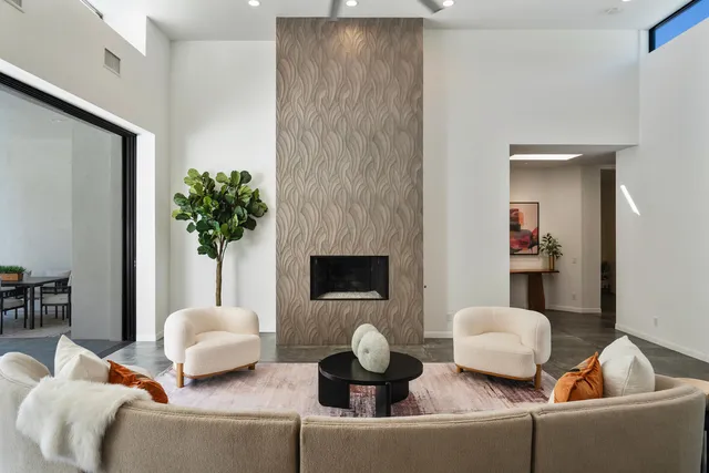 a living room with stainless steel appliances granite countertop furniture and a dining table