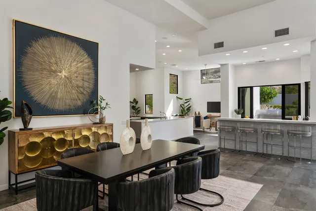 a living room with furniture and a view of kitchen