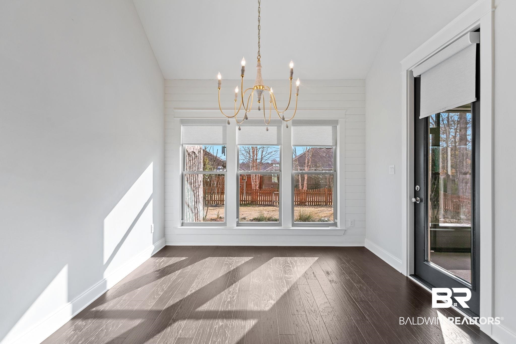 31654 Canopy Loop Daphne, AL 36527 - Photo 24 of 64 Unfurnished dining area featuring a chandelier, dark wood-style floors, and lofted ceiling
